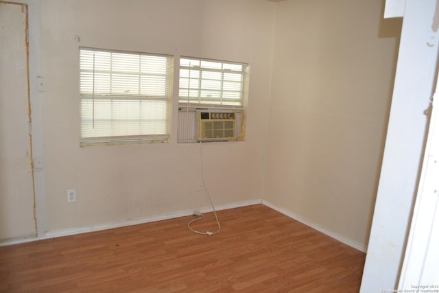 spare room with hardwood / wood-style floors and cooling unit