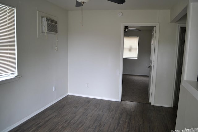 empty room with dark hardwood / wood-style floors and a wall mounted AC