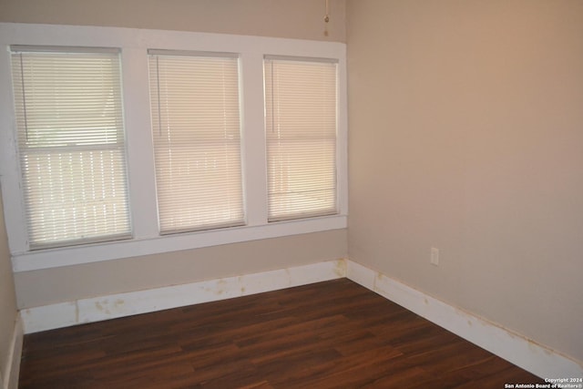 empty room featuring dark hardwood / wood-style flooring