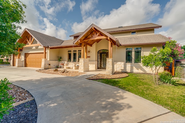 view of front of property with a front yard and a garage