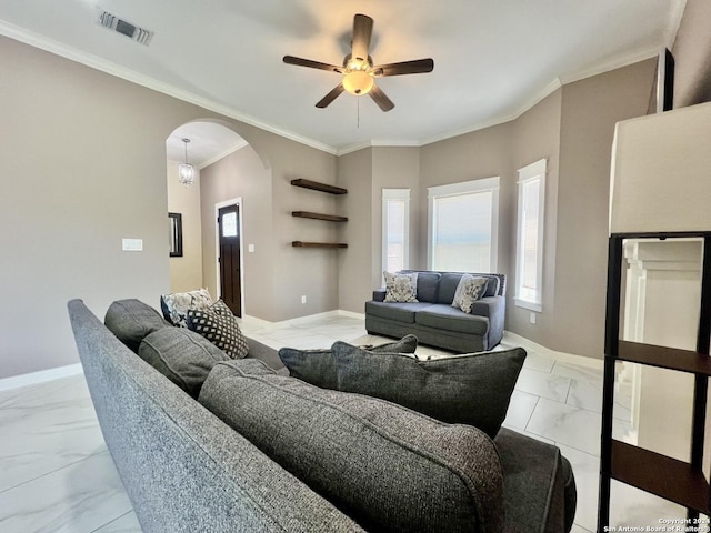 living room with ceiling fan and ornamental molding