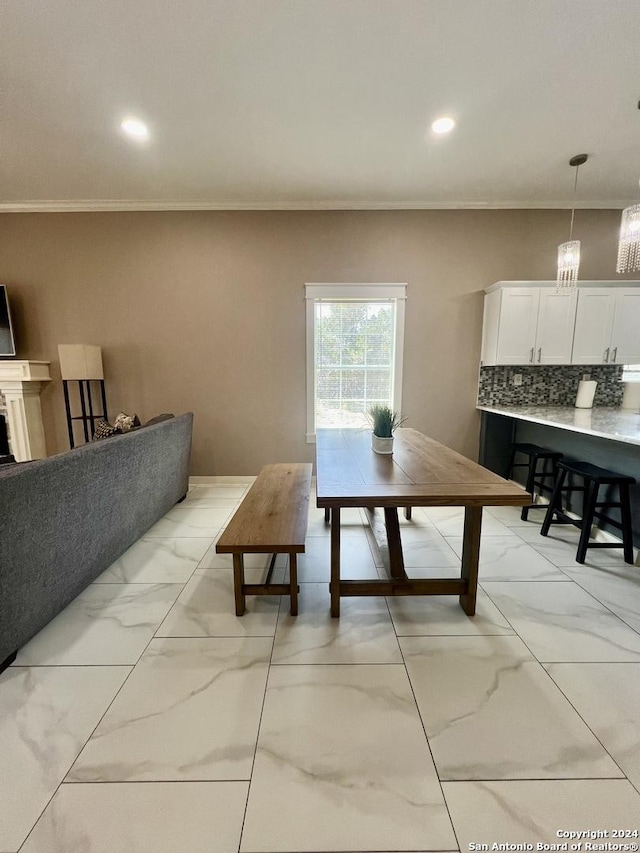 dining space with crown molding