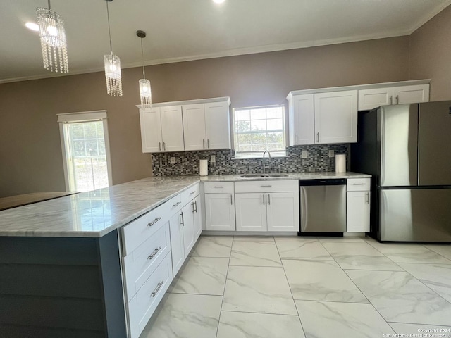 kitchen with pendant lighting, white cabinetry, sink, and stainless steel appliances