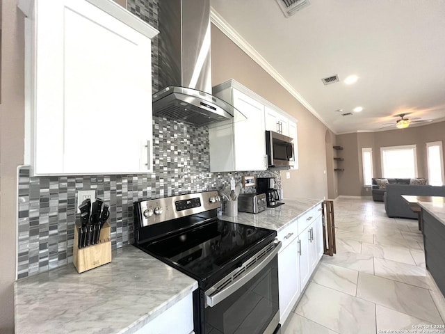 kitchen with appliances with stainless steel finishes, backsplash, ornamental molding, wall chimney range hood, and white cabinets