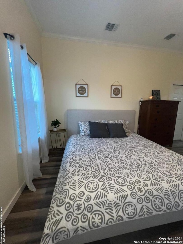 bedroom featuring dark hardwood / wood-style flooring and ornamental molding