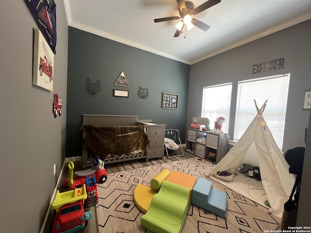 playroom with ceiling fan, light hardwood / wood-style floors, and ornamental molding