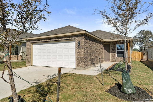 single story home with a front yard and a garage