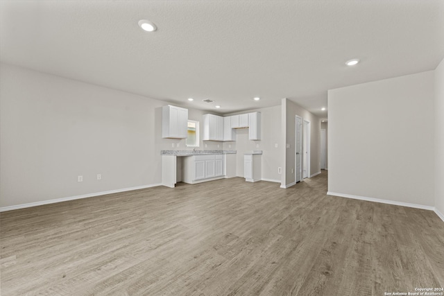 unfurnished living room with light hardwood / wood-style floors