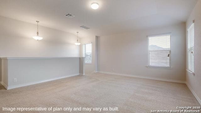 carpeted spare room with a healthy amount of sunlight