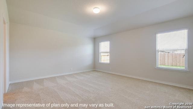 unfurnished room featuring light carpet