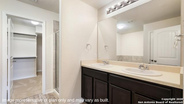 bathroom with vanity and a shower with shower door