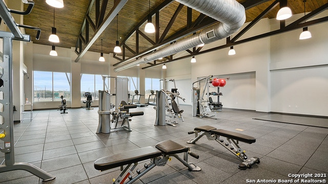 gym featuring high vaulted ceiling and wooden ceiling