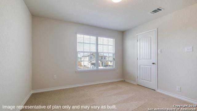 unfurnished room with light carpet