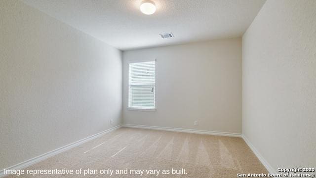 carpeted spare room featuring a textured ceiling