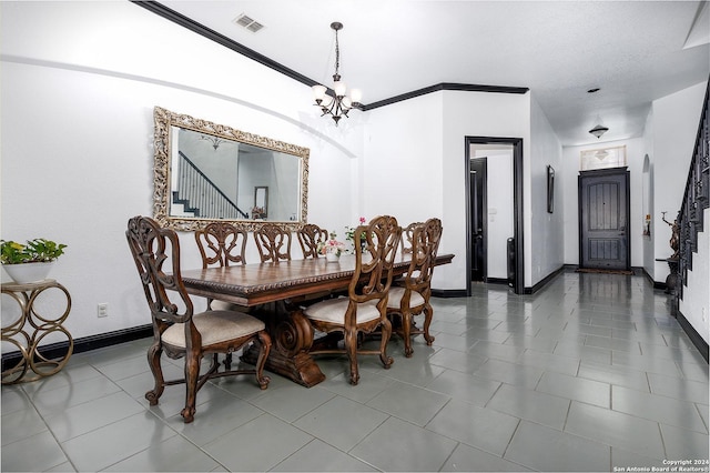 dining space with crown molding and an inviting chandelier