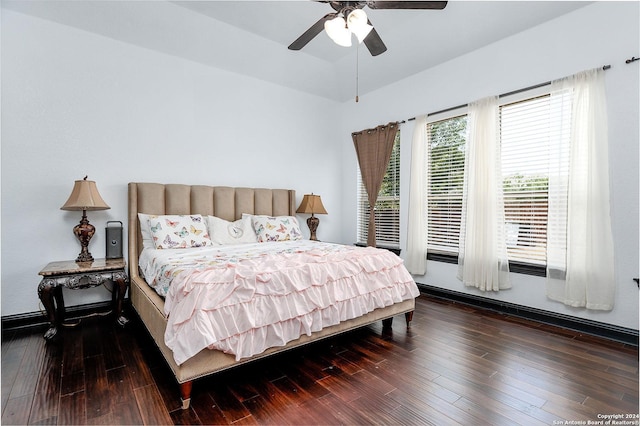 bedroom with dark wood-type flooring, ceiling fan, and vaulted ceiling