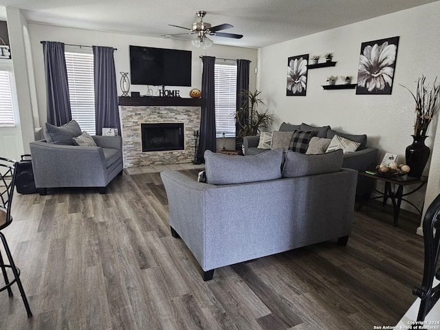 living room featuring a healthy amount of sunlight, wood-type flooring, ceiling fan, and a fireplace