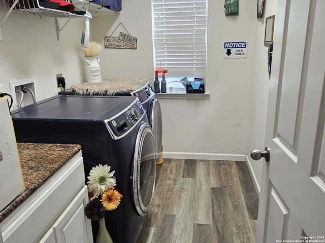 clothes washing area with washer hookup, separate washer and dryer, hardwood / wood-style floors, and hookup for an electric dryer