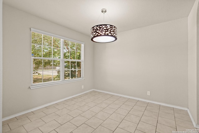 tiled spare room with a healthy amount of sunlight