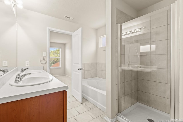 bathroom with shower with separate bathtub, vanity, a textured ceiling, and tile patterned floors