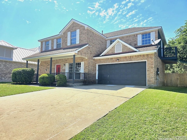 view of front of property featuring a front yard, covered porch, and a garage