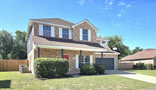 front of property featuring covered porch, a front yard, a garage, and central AC