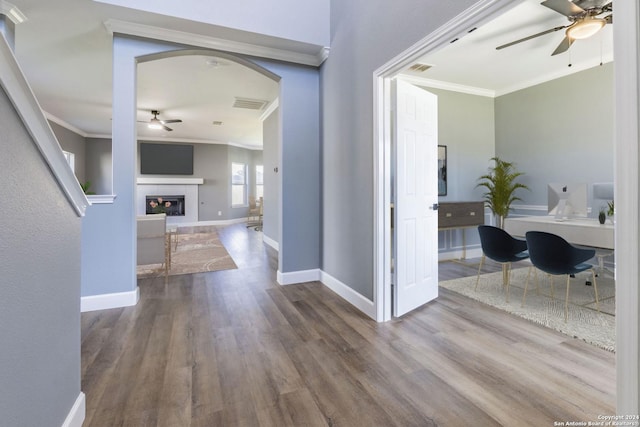 hall featuring hardwood / wood-style flooring and crown molding