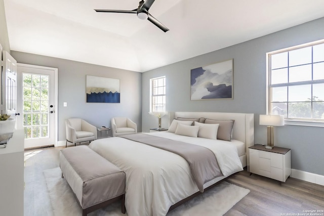 bedroom with ceiling fan, access to exterior, and light hardwood / wood-style floors