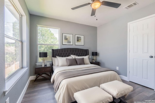 bedroom with ceiling fan and dark hardwood / wood-style flooring