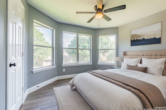 bedroom with ceiling fan and hardwood / wood-style floors