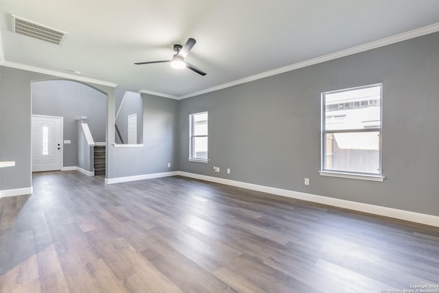 unfurnished living room featuring ceiling fan, wood-type flooring, and ornamental molding