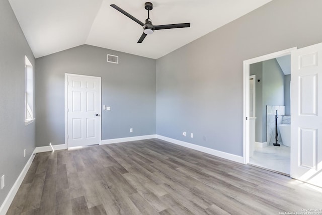 spare room featuring lofted ceiling, ceiling fan, and light hardwood / wood-style flooring