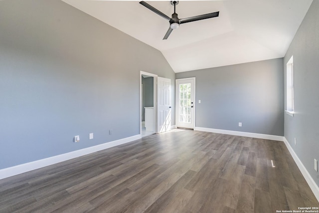 unfurnished room featuring ceiling fan, vaulted ceiling, and dark wood-type flooring