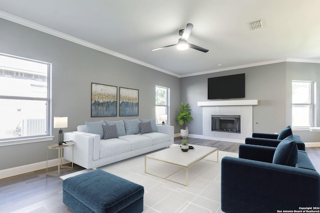 living room with ceiling fan, light hardwood / wood-style floors, and ornamental molding