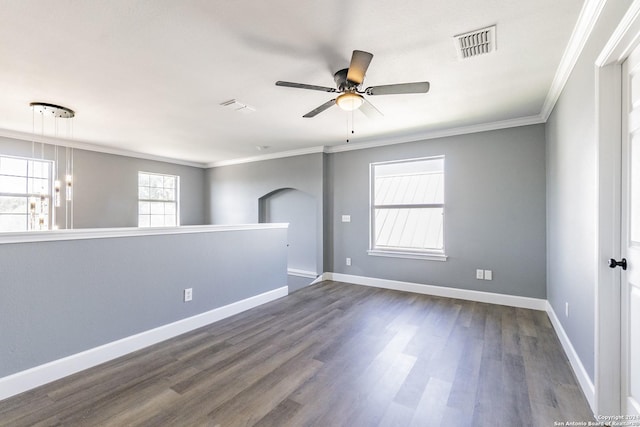 empty room featuring ceiling fan, dark wood-type flooring, and ornamental molding