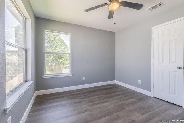 unfurnished room featuring ceiling fan and dark hardwood / wood-style flooring