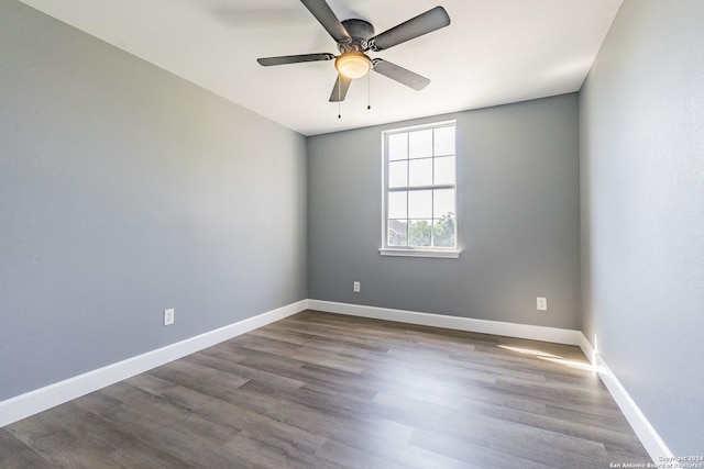 spare room with ceiling fan and wood-type flooring