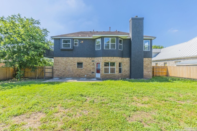 rear view of property featuring a yard