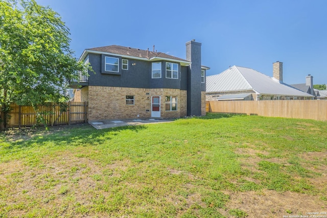 rear view of house with a lawn