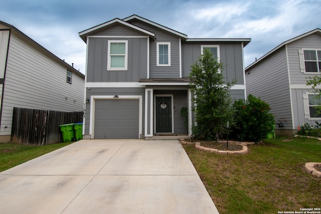 front facade with a front lawn and a garage