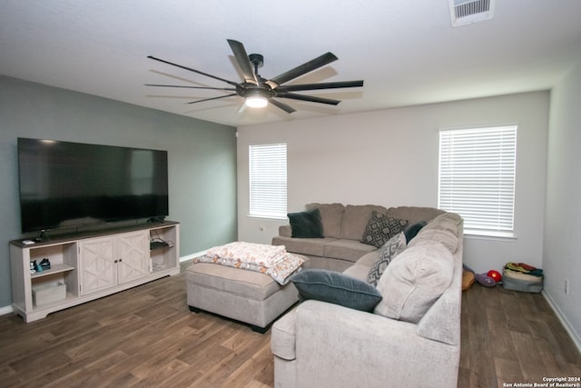 living room with dark hardwood / wood-style floors and ceiling fan