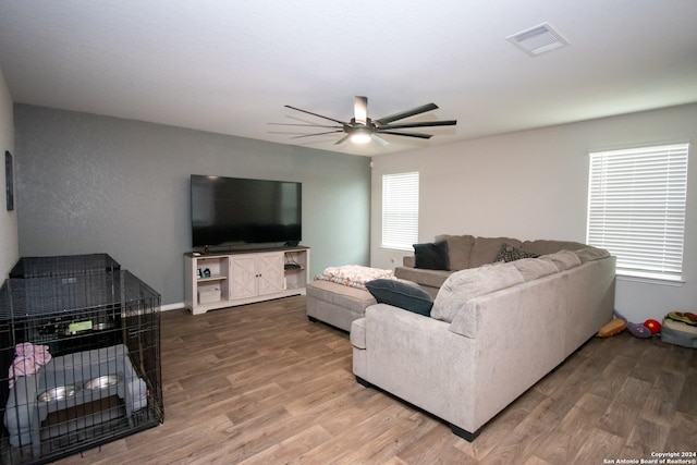 living room featuring a healthy amount of sunlight, hardwood / wood-style flooring, and ceiling fan