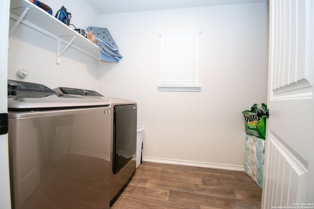 laundry room with washer and dryer and hardwood / wood-style floors