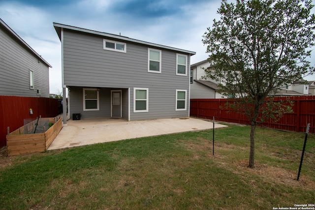 rear view of property with a lawn and a patio area