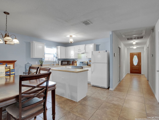 kitchen with stainless steel range with electric stovetop, a textured ceiling, a chandelier, white cabinets, and white fridge