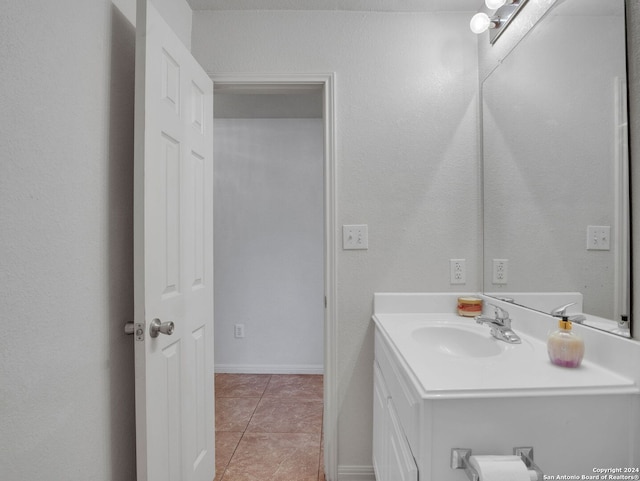 bathroom featuring tile patterned flooring and vanity