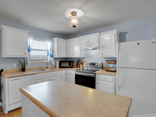 kitchen with a textured ceiling, white appliances, white cabinetry, and sink