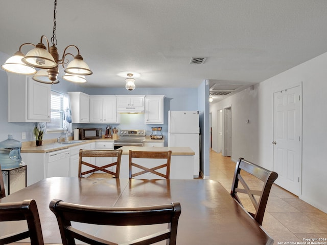 kitchen with white cabinetry, sink, a textured ceiling, decorative light fixtures, and white appliances