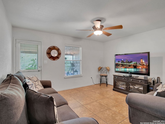 tiled living room with ceiling fan and a healthy amount of sunlight