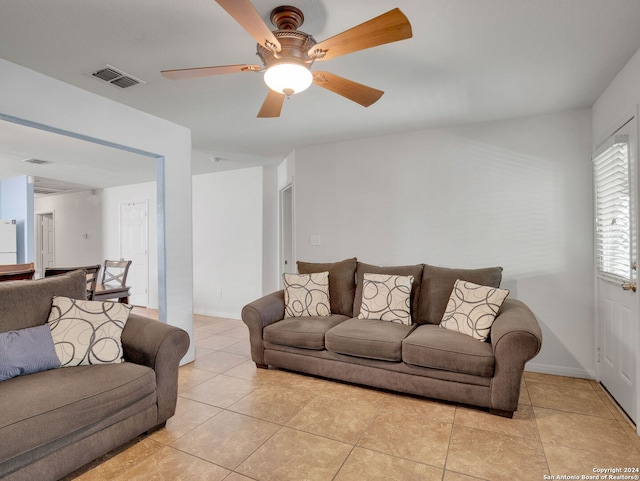 tiled living room with ceiling fan